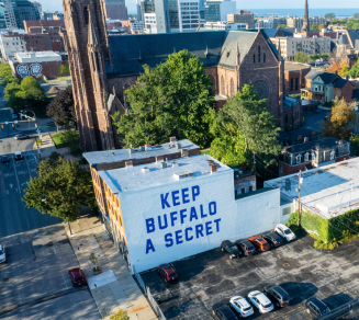 A mural with the text ‘Keep Buffalo A Secret’ is displayed on a building on Main Street in downtown Buffalo. NY.