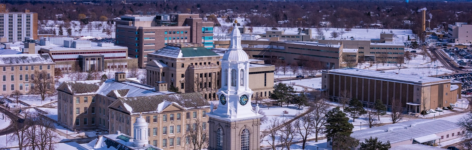 Aerial view of snowy UB South Campus in winter.
