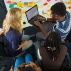 students gathered around a computer. 