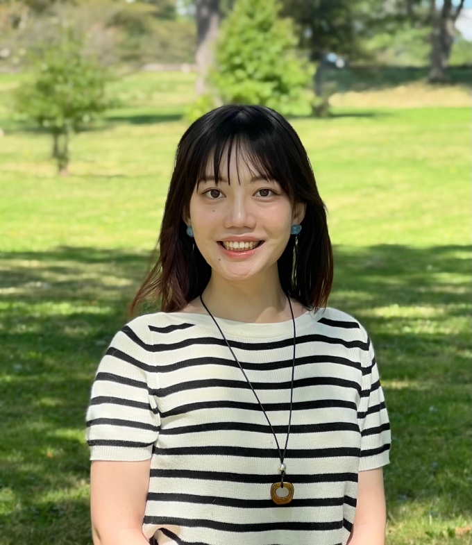 A smiling woman with dark, long hair.