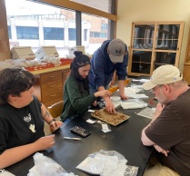 Faculty, staff and students working in Archaeological Survey space at UB.