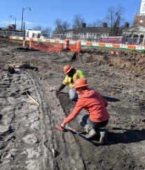 Two Archaeological Survey workers outside in a trench at the AKG Art Museum construction project.