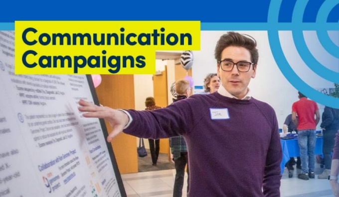 Person pointing to a poster board.