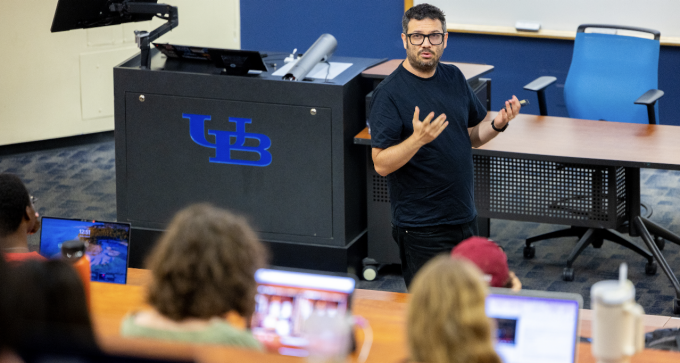 Professor Yotam Ophir is teaching in a lecture hall.