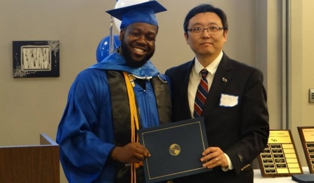 a picture of a UB geography professor Granting award to a student.