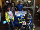 Family with 2 kids pose with bike