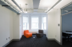 An alcove at the end of a hall on the first floor. The bay windows provide natural light.