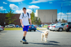 The surest sign of spring is when we see students like Jacob Leverett (along with his dog, Louis) traversing the campus in shorts and on a skateboard.