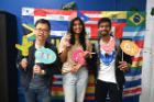 Students pose with props at the 2024 Hispanic Heritage Month mixer.