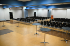 Lecture-style seating is available for up to 300. Picture shows 145 All, seating for 200 with a podium, and reception area in the back with bistro tables.