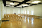 Lecture-style seating is available for up to 180, with space for refreshments and presentation. Photo shows seating for 160 with a podium.