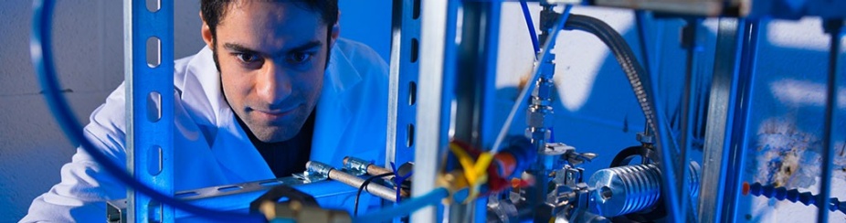 Parham Rohani working with wires in an engineering lab.