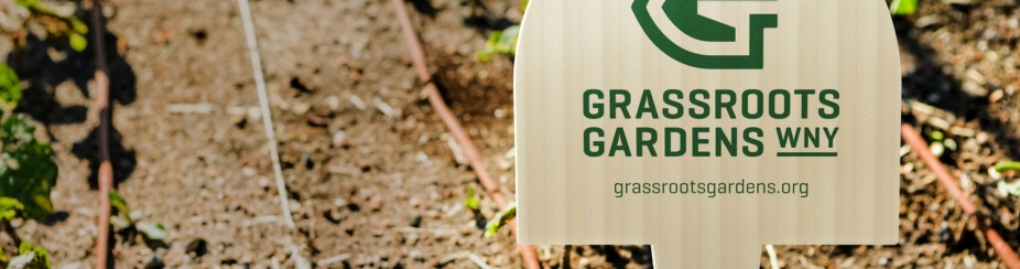 Grassroots Gardens sign among new seedlings.