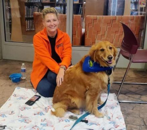 a therapy dog from paws for love and their handler. 