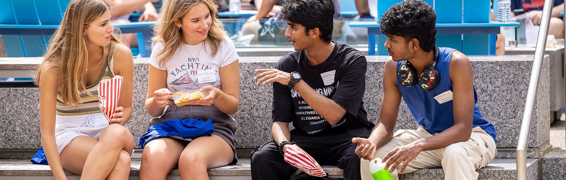 Group of students around a table have a discussion.