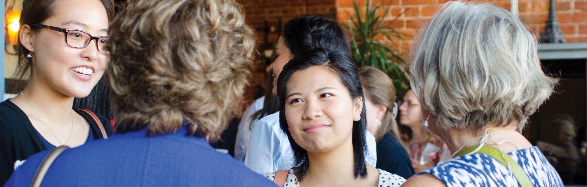 UB grads talking to current students at an event.