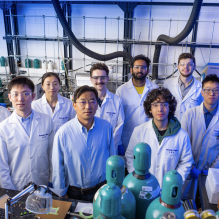 Gang Wu stands with researchers.