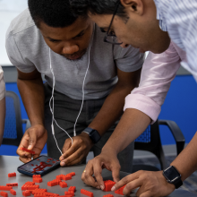 The 2023 class of Social Impact Fellows gathered for an icebreaking activity working with Legos at Clemens Hall in May 2023.