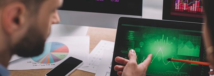 Students analyzing data on various devices.