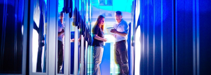 People talking in a data server room.