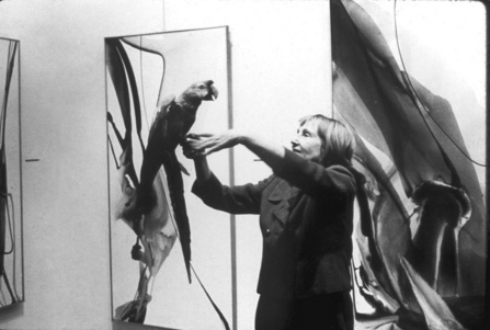 Martha Jackson with Chuckie, a parrot, on her arm.