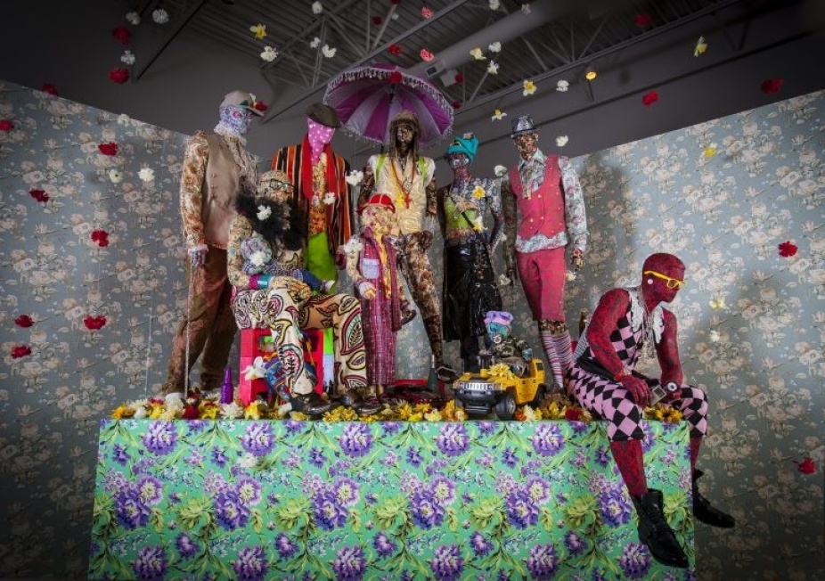 Photography of installation with various patterned clothing on mannequins.