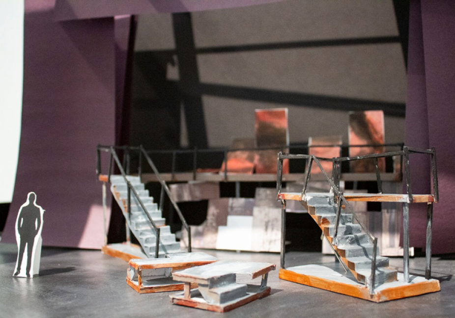 a photo of a small model of a set for Three Penny Opera with modular stairs and a small scale model person.