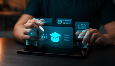 image of hands working on an AI-generated image coming out of the computer with the letters AI and a graduation cap.