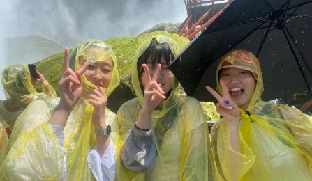 Korean students wearing yellow rain ponchos.