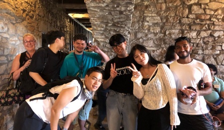 Korean students wearing yellow rain ponchos.
