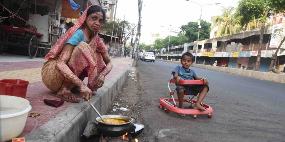 Photo caption: A homeless woman cooking on the street during government-imposed lockdown as a preventive measure against the COVID-19 coronavirus in Dhaka, Bangladesh, on April 10, 2020.