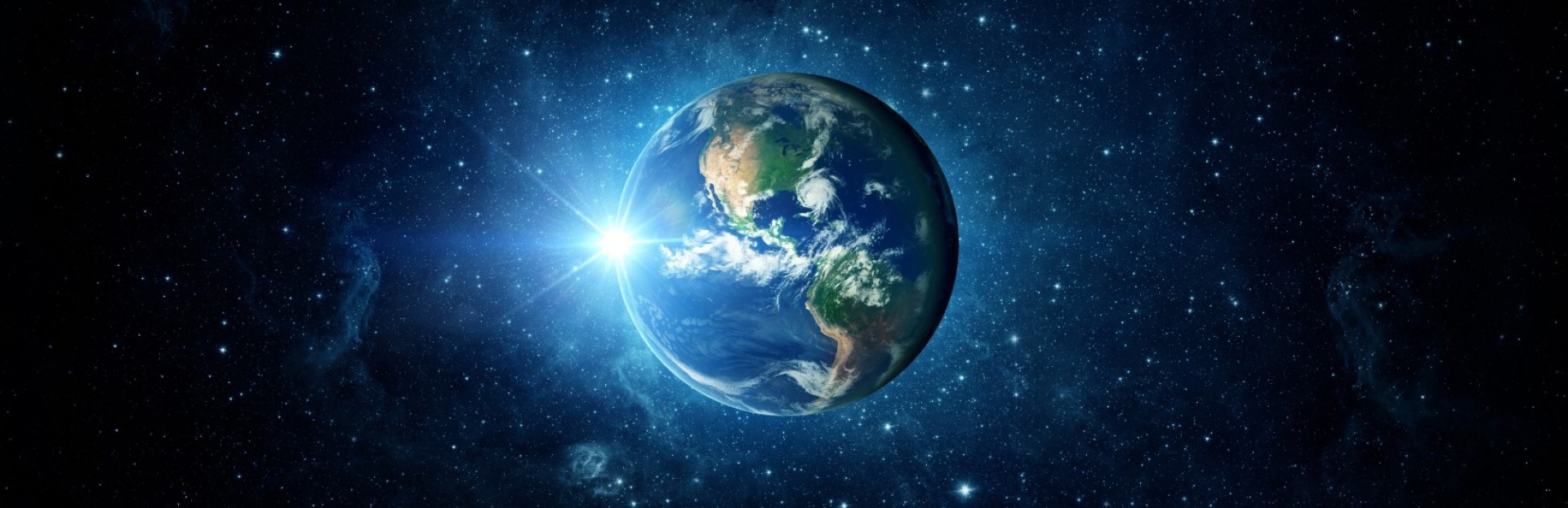 Planet Earth glows amid a dark field of stars.