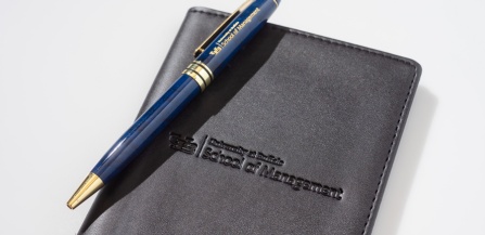 School of Management promotional pen and notebook.