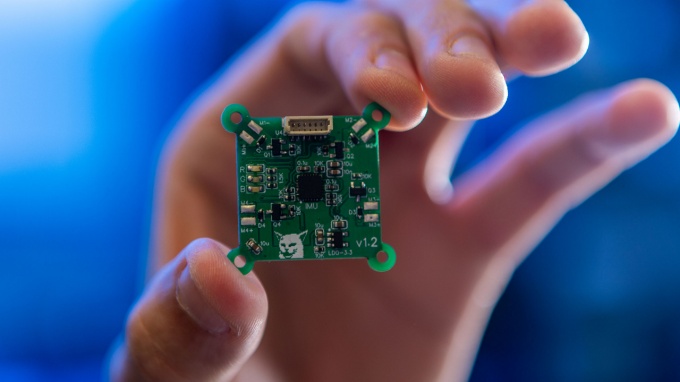 Hands working with circuits.