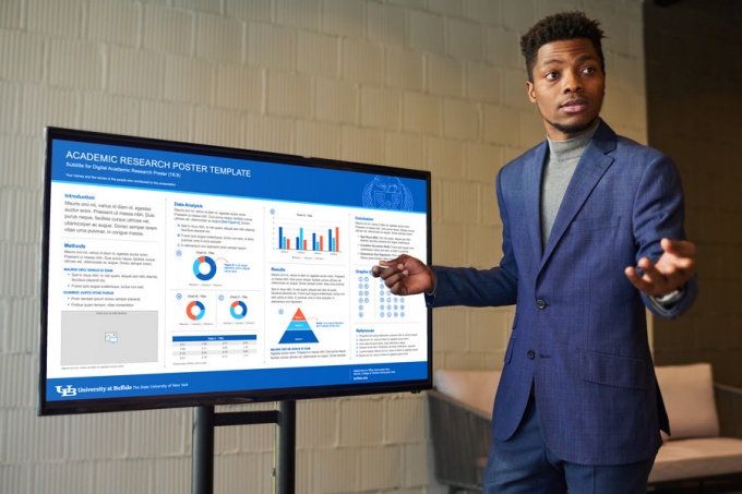 A student presenting a poster using UB's digital poster template.