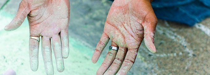 Hands of artist using chalk.