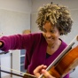 A UB instructor annotates a score with a student violinist. 