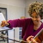 A UB instructor annotates a score with a student violinist. 