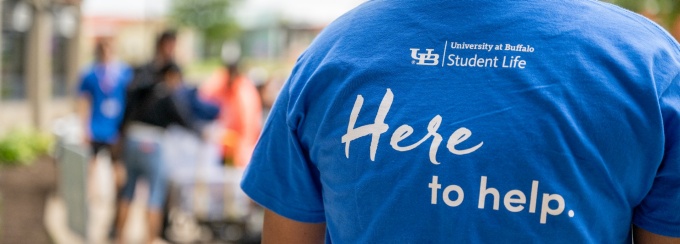 Back of a tshirt that says "Here to Help".