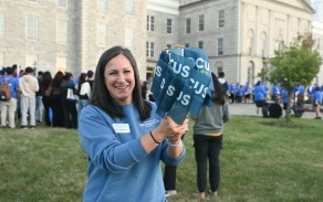 Staff member holding mini FOCUS flags at the 2025 FOCUS event.