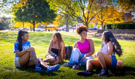 Students with fall foliage on South Campus and along Main Street.