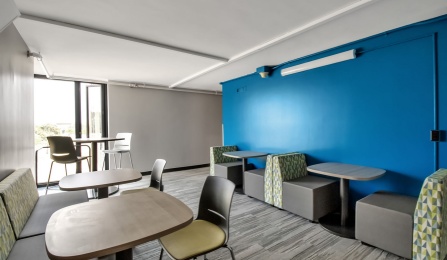 Floor lounge in governors complex with chairs and cafe seating,.