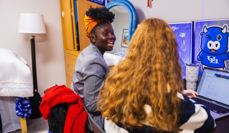 Students talking in dorm room of Governors Residence Halls on the North Campus.