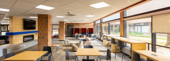 Lounge area in the landing with a tv above the electric fireplace.