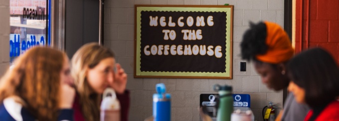 4 students sitting at a table in the wilkeson coffee house.