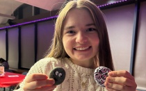 Student posing with painted rocks at RHA event. 