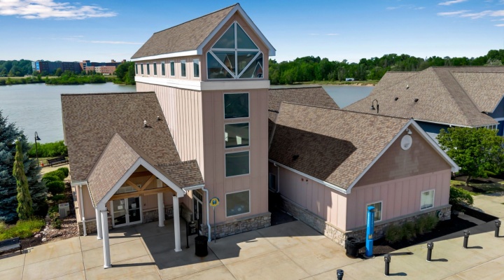 Exterior shot of South Lake Village Community Building with the lake in the background.