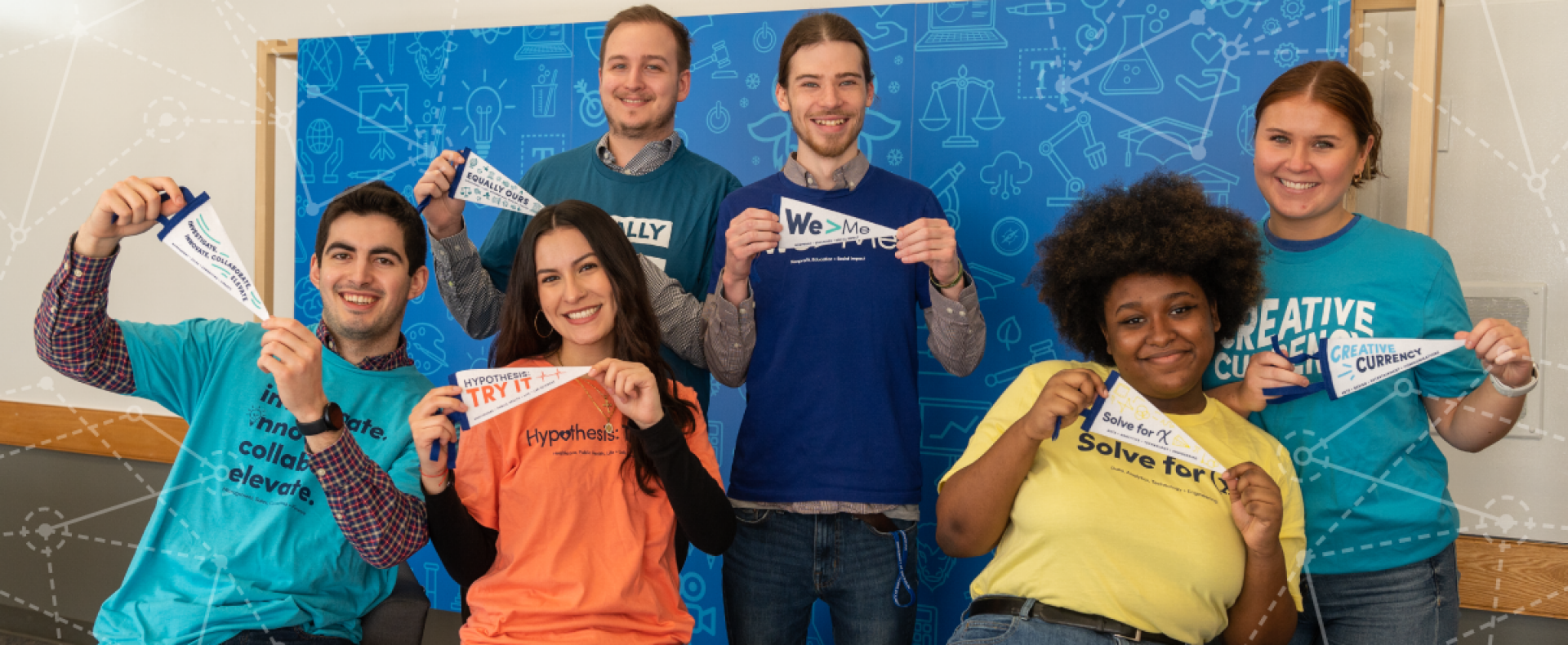 Six UB students holding Career Community pennants.