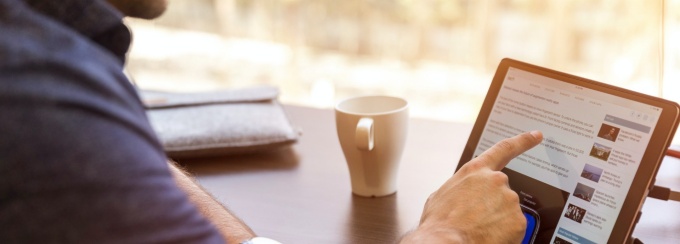 Image of a man working on a tablet. 