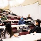 Image of a group of students in a UB classroom. 